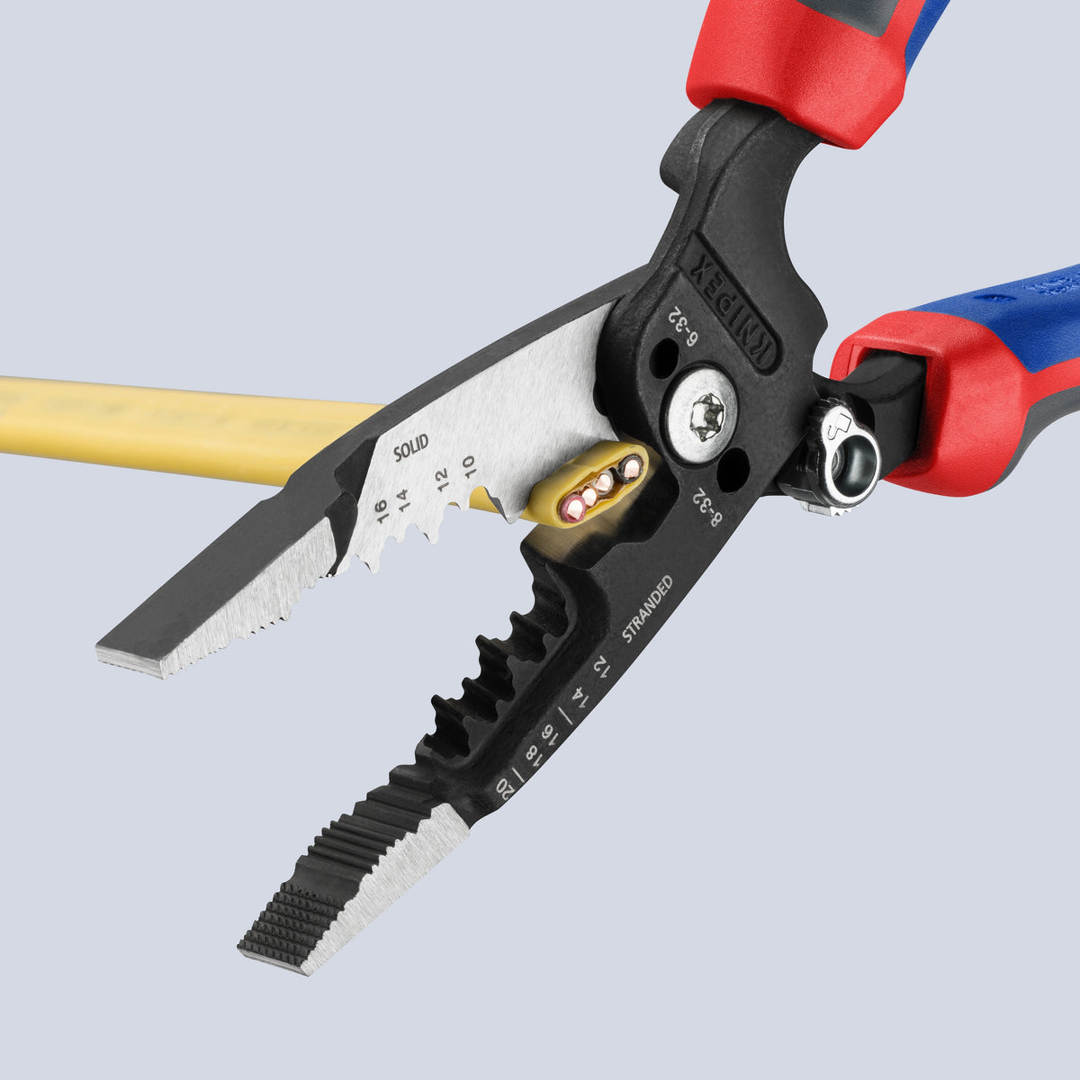 KNIPEX 13 72 8 Forged Wire Stripper cutting through yellow non-metallic sheathed NM-B electrical cable.