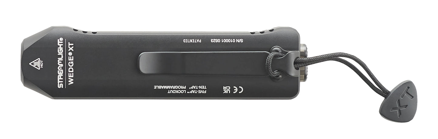 Top-down flat profile view of the black Streamlight Wedge XT EDC flashlight, focusing on the heavy-duty black pocket clip, printed model branding, and the attached tactical wrist lanyard with a branded toggle.