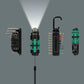 Lineup of the four main components from the Wera 2026 tool calendar, featuring the metric hex keys, a glowing Flashdriver torch casting a bright beam of light, the bit holder with carabiner clip, and the bit handle.