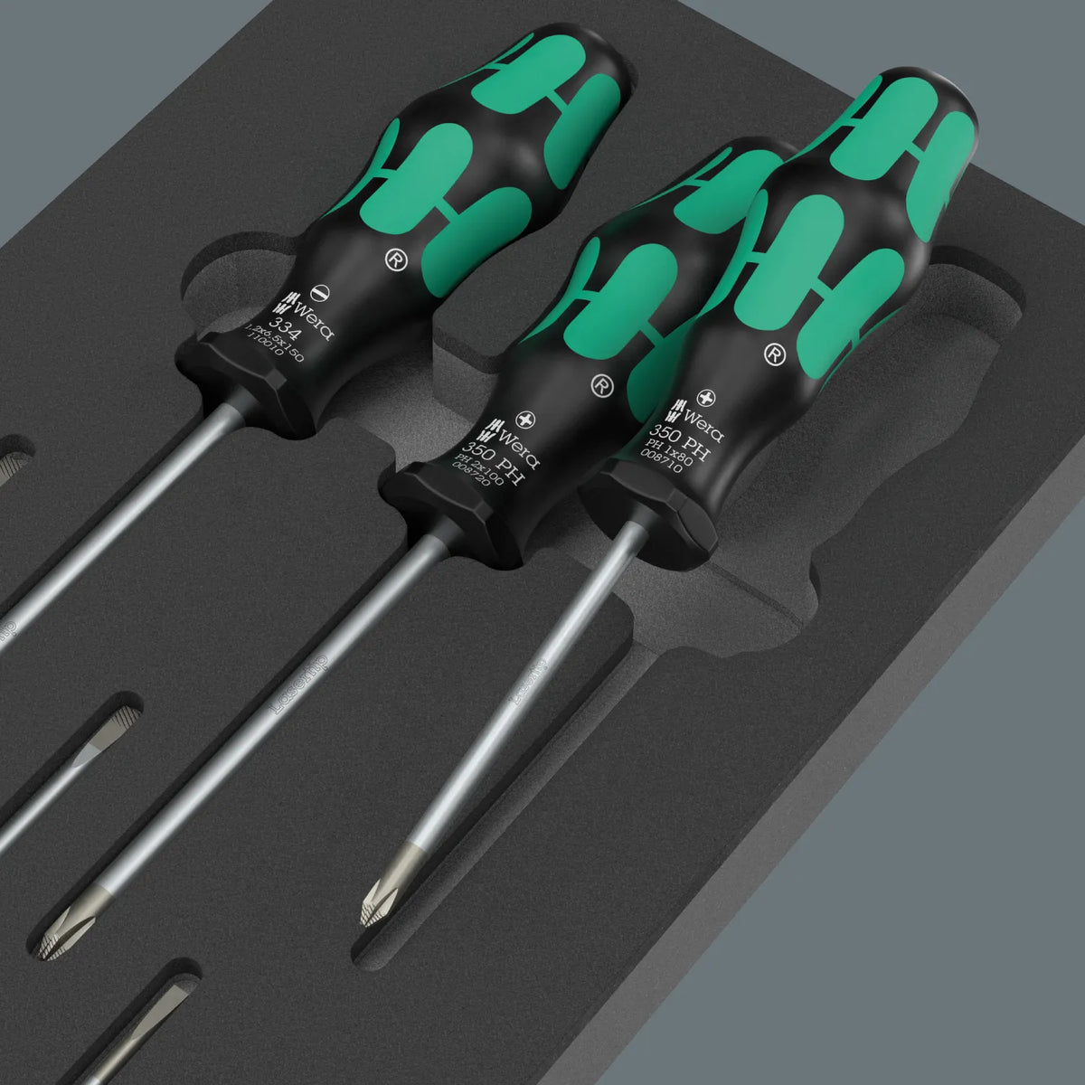 Close-up view of Wera Kraftform Series 300 Phillips and slotted Lasertip screwdrivers resting in a shadow foam insert