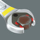 Close-up showing the double-hex geometry jaw of a Wera Joker 6002 open-end spanner gripping a hexagonal bolt head with red contact highlight points.