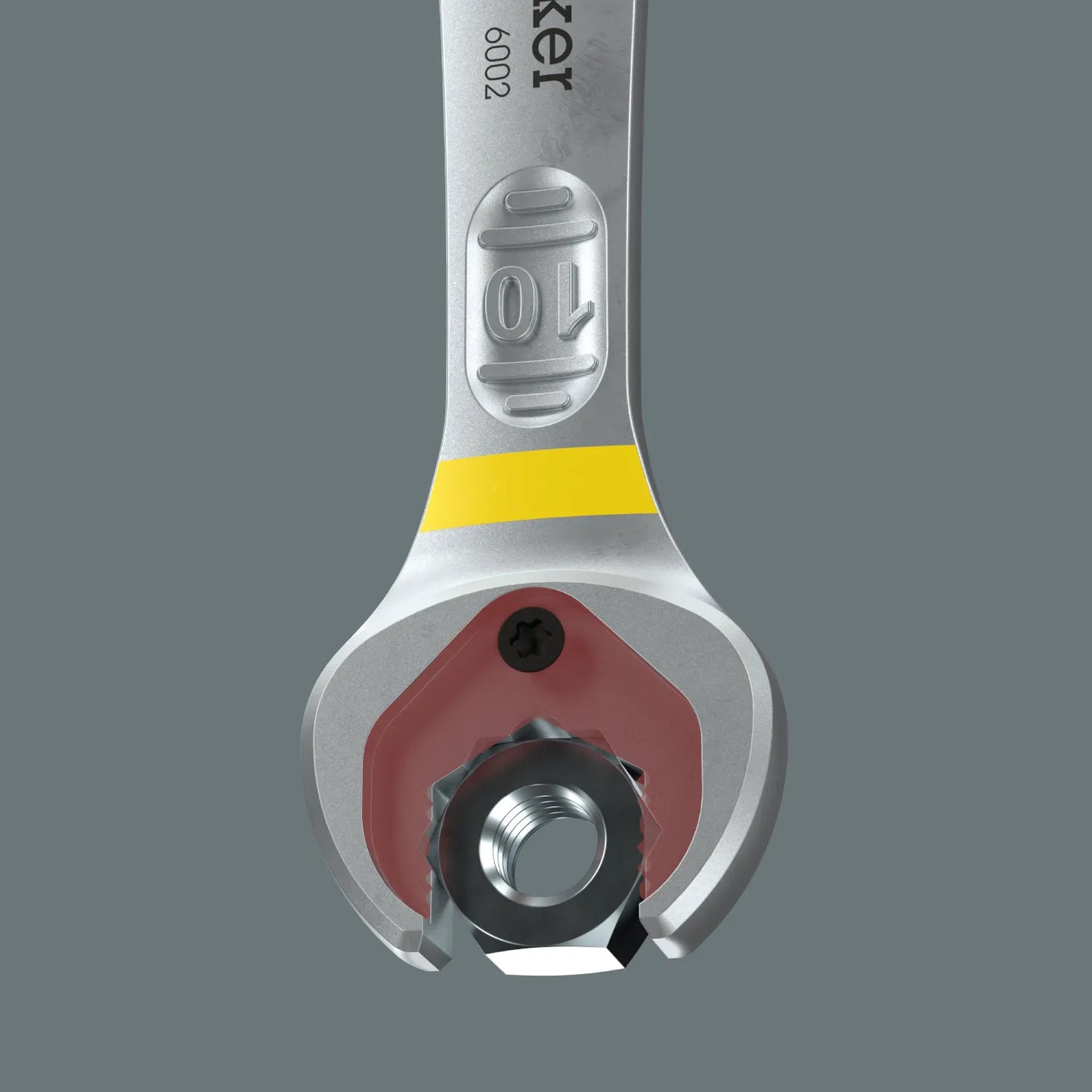 Direct view of the Wera Joker 6002 spanner open jaw using its integrated metal plate holding function to secure a hex nut inside the jaw.