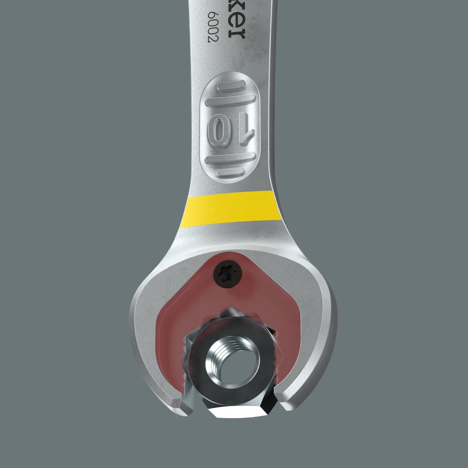 Direct view of the Wera Joker 6002 spanner open jaw using its integrated metal plate holding function to secure a hex nut inside the jaw.