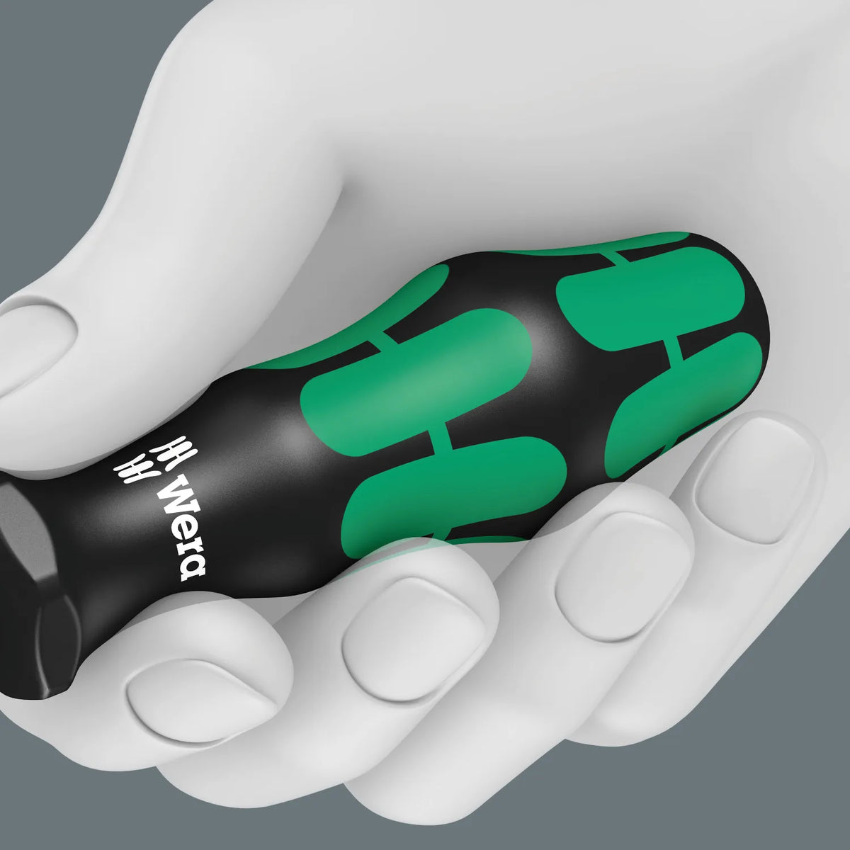 Hand gripping a Wera Kraftform multi-component screwdriver handle displaying its ergonomic shape