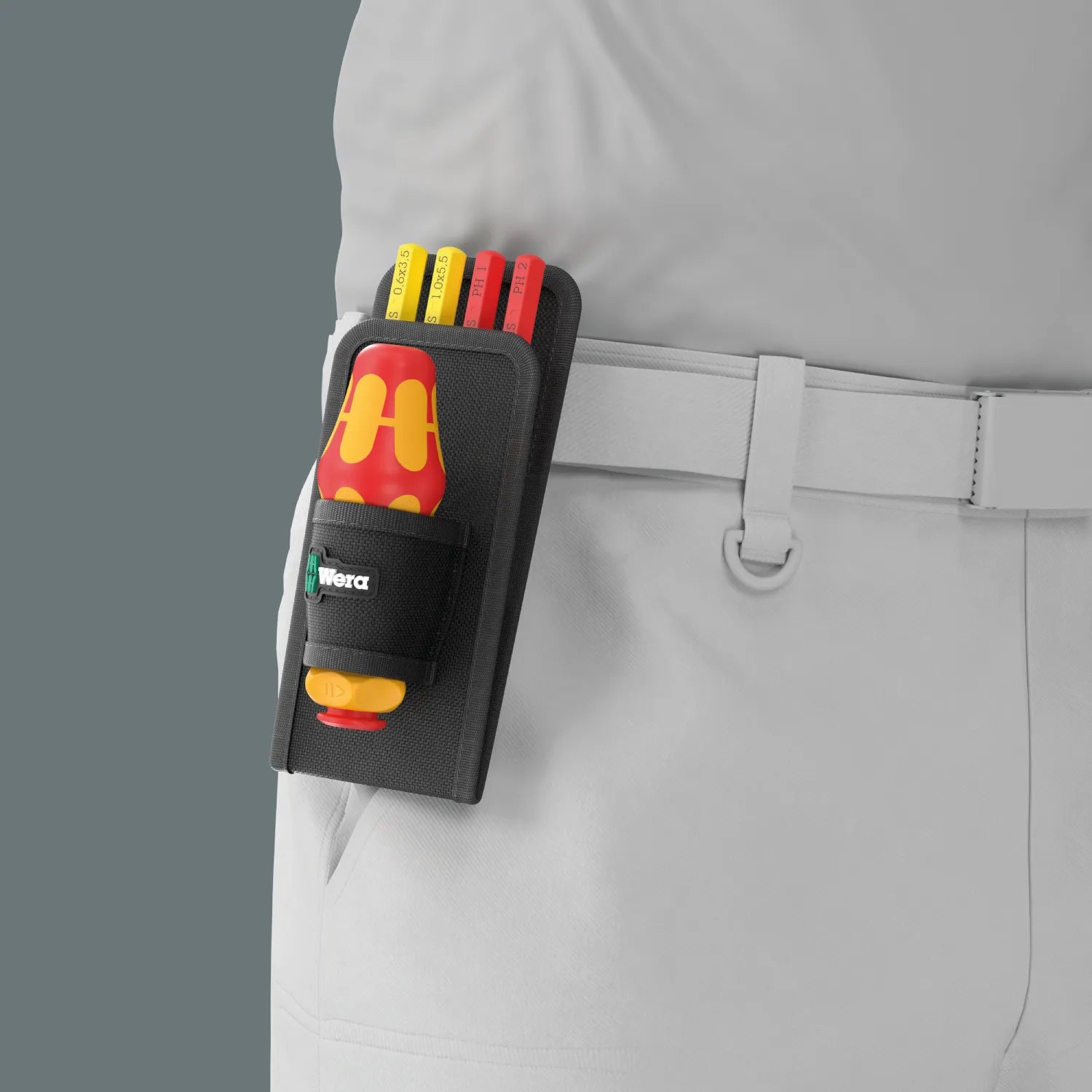 Wera 9594 textile holster mounted on work pants belt storing VDE ratcheting handle and Take It Easy color-coded blades.