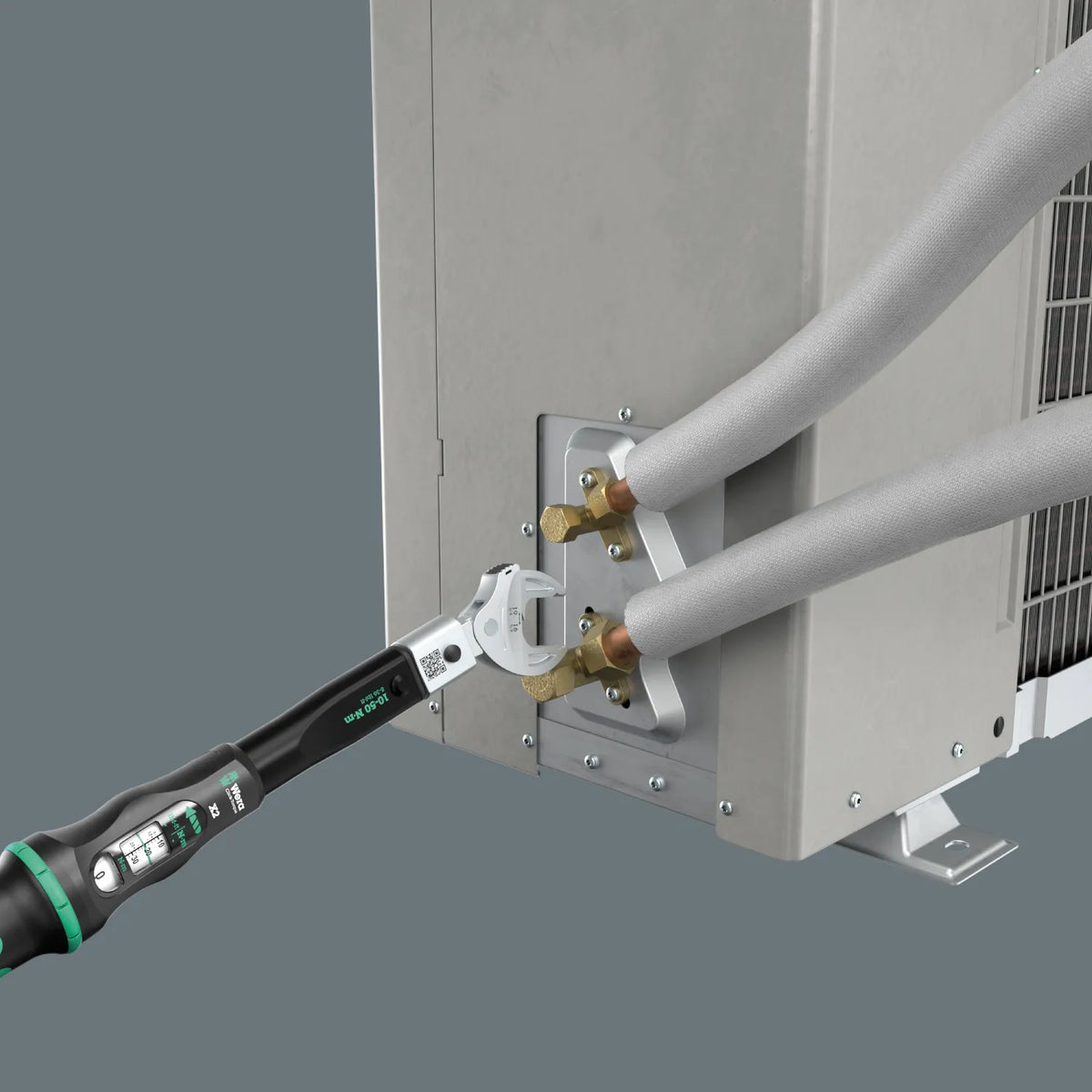 Wera 9558 torque wrench in use tightening brass flare nut fittings on an HVAC outdoor mini-split unit
