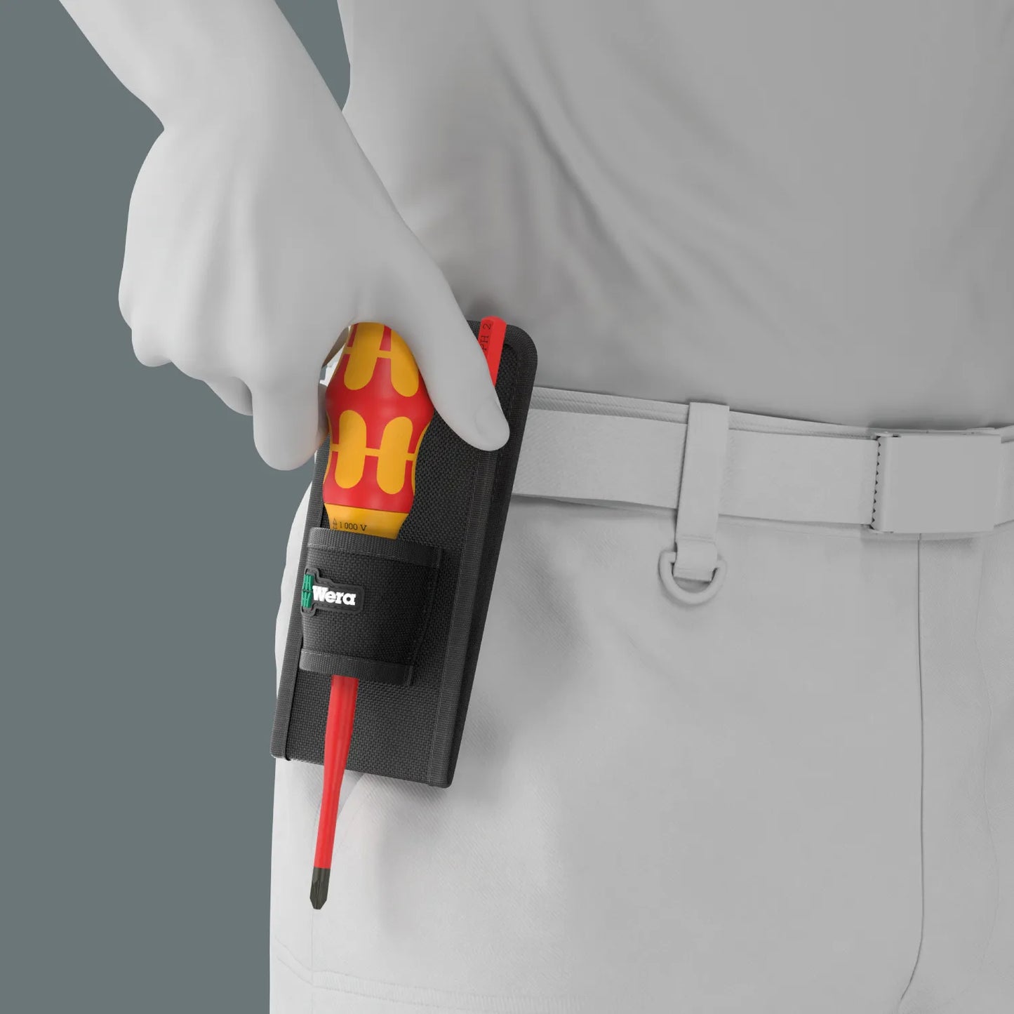 Electrician drawing the Wera Kraftform VDE ratcheting screwdriver handle directly from the compact belt holster pouch.
